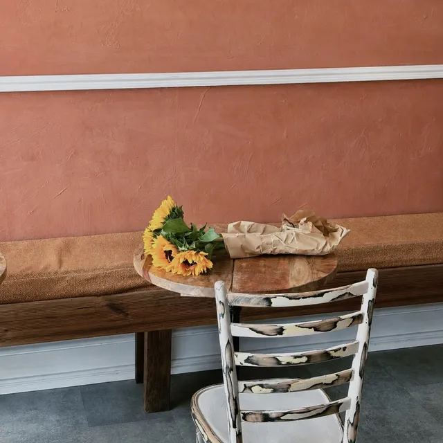 Sunflowers resting on a wooden bench
