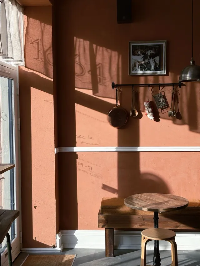 Sunlight falling across the terracotta wall