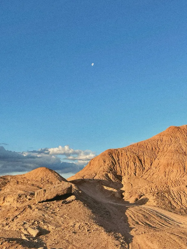 The moon over the mountains near the family's hometown
